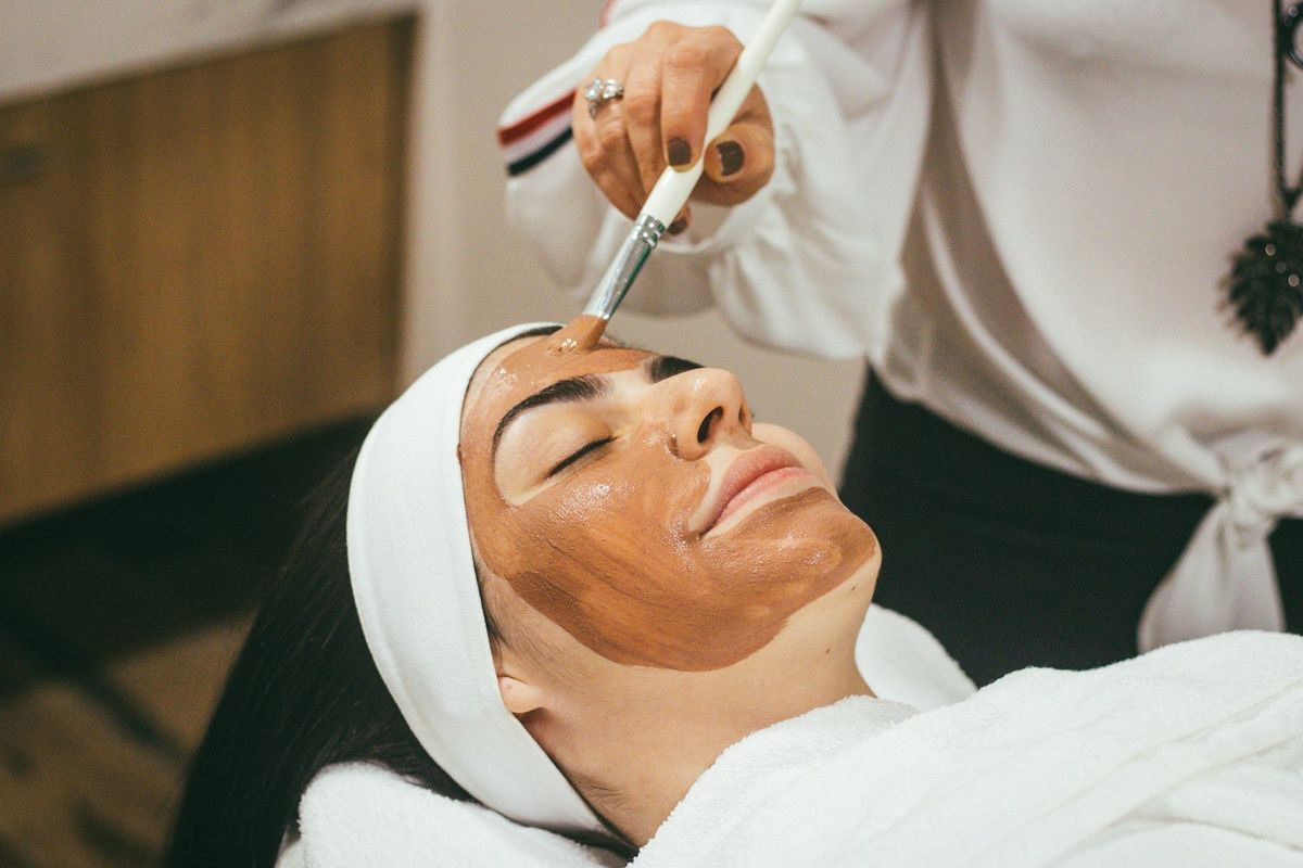 A practitioner treating a client in an aesthetics practice